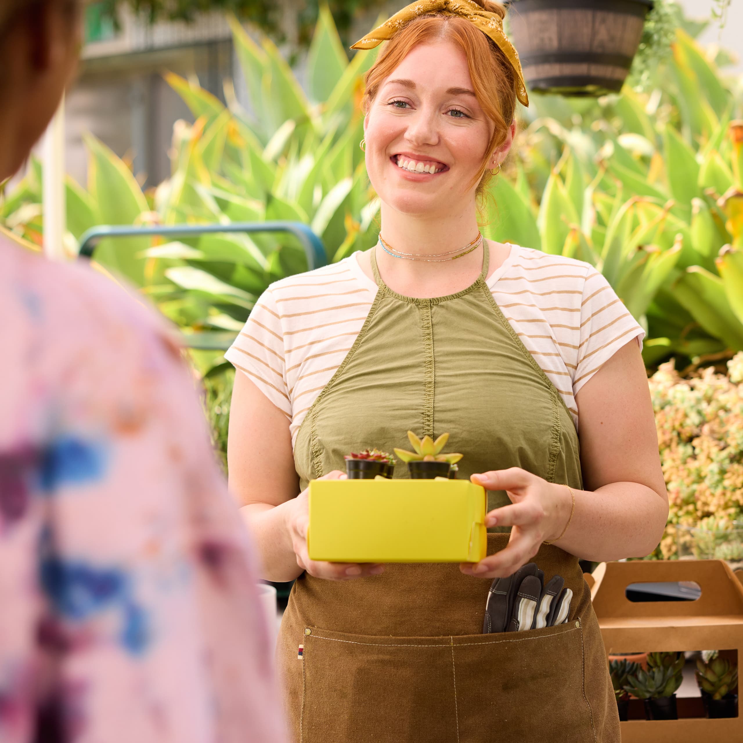 A shop owner handing a customer an order